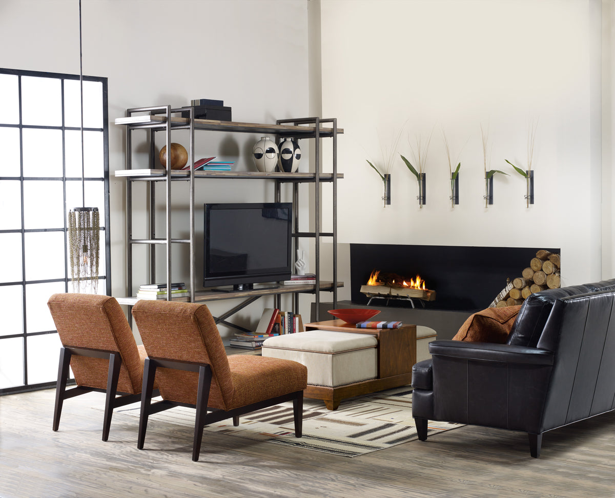 a living room with a fireplace and chairs