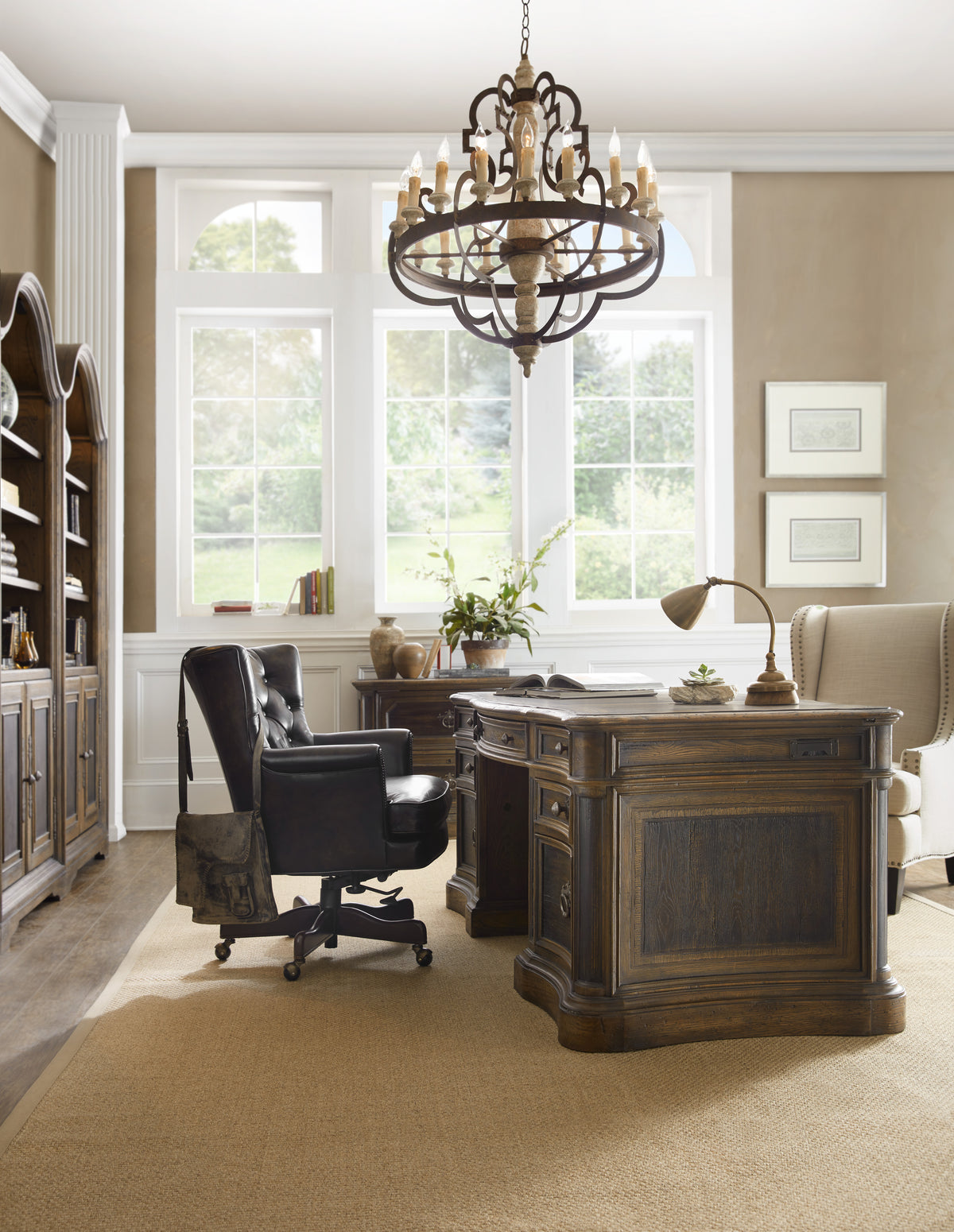 a room with a desk chair and a chandelier