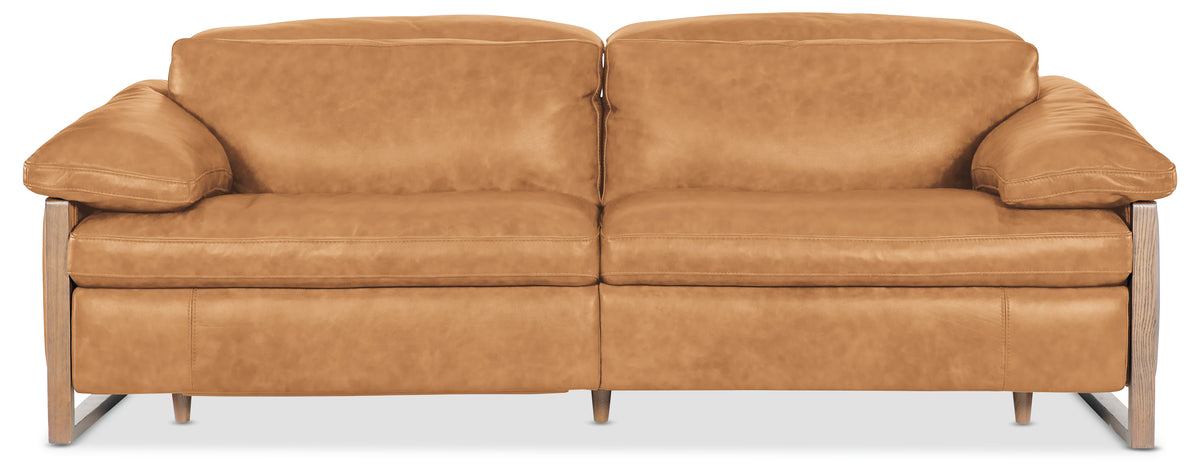 a brown leather couch with wooden legs
