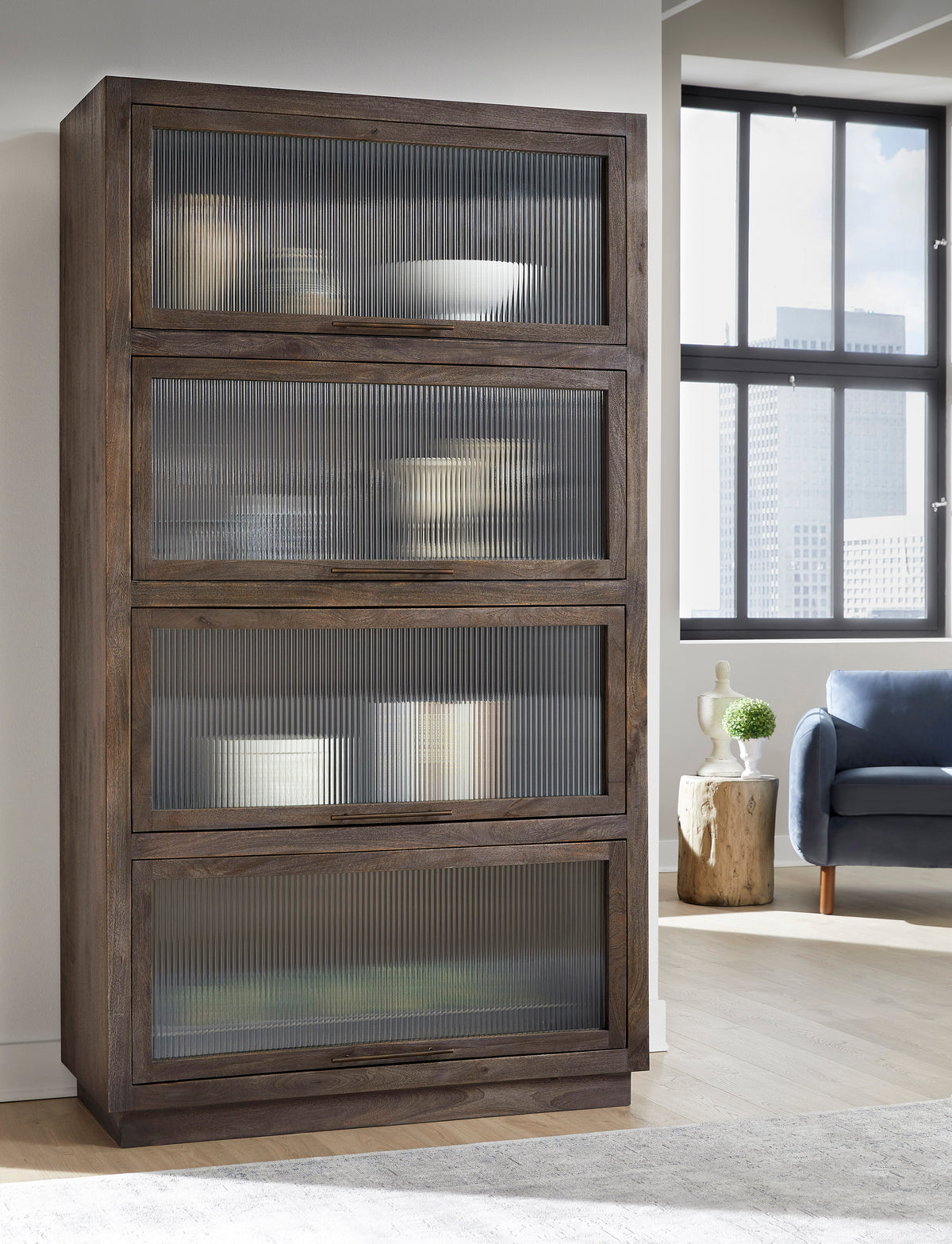 a tall wooden cabinet with glass doors