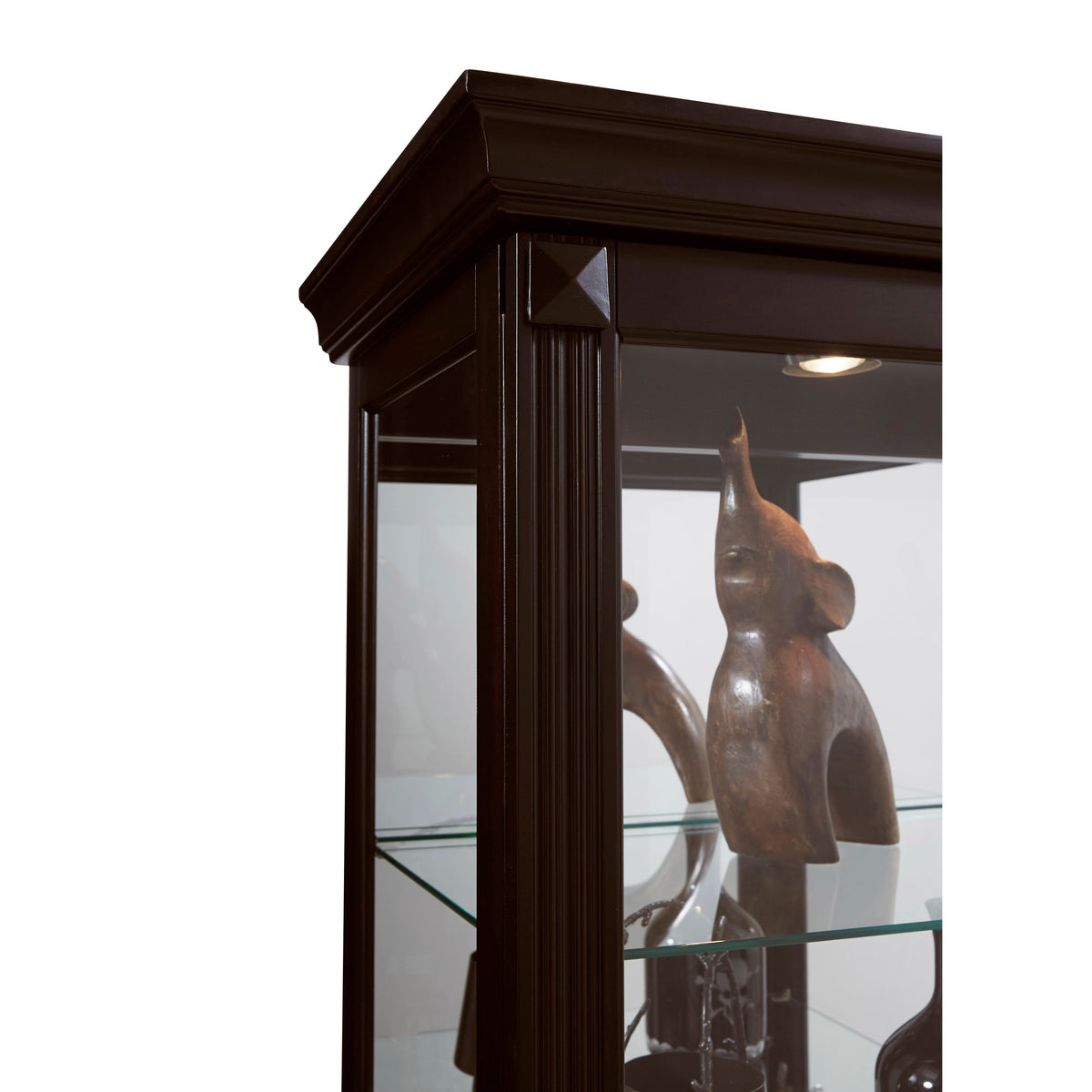 a glass case with a wood sculpture