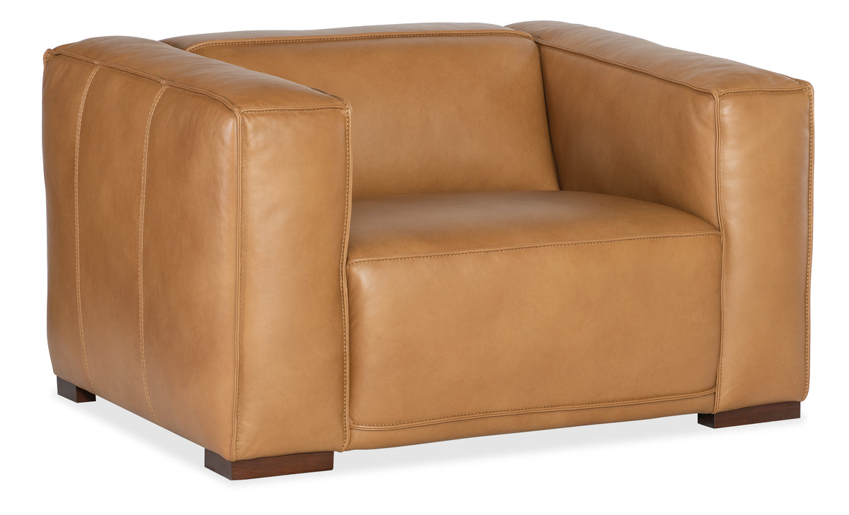 a brown leather chair with wooden legs