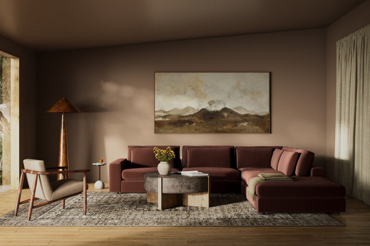 a living room with a couch and a painting on the wall