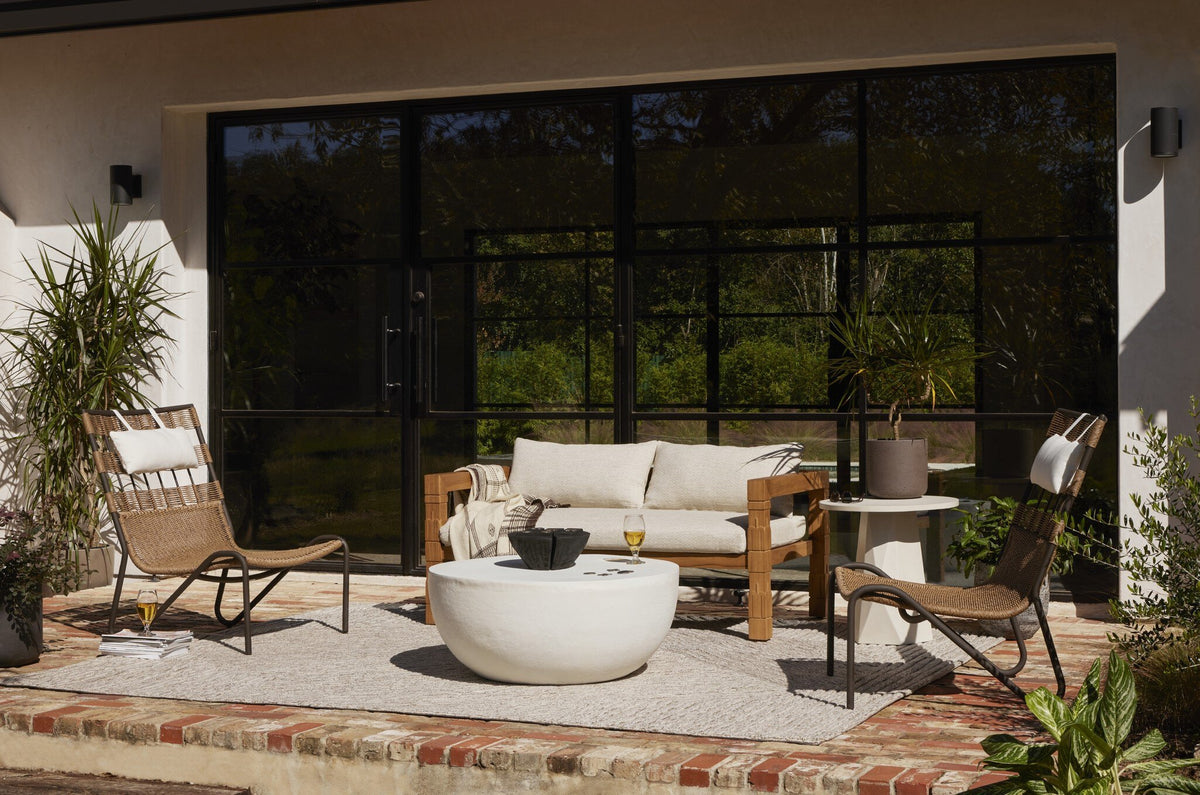 a patio with a white table and chairs