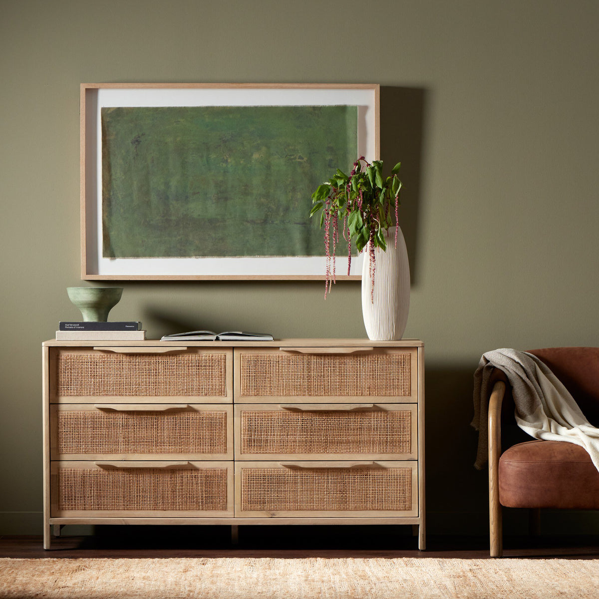 a dresser and chair in a room