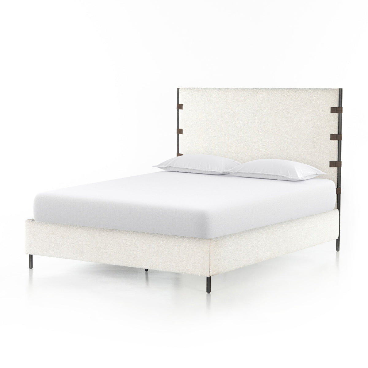 a bed with white sheets and pillows