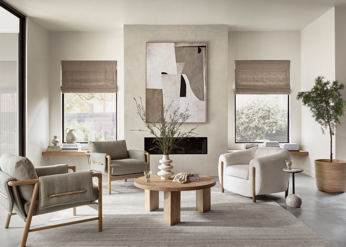 a living room with a fireplace and chairs