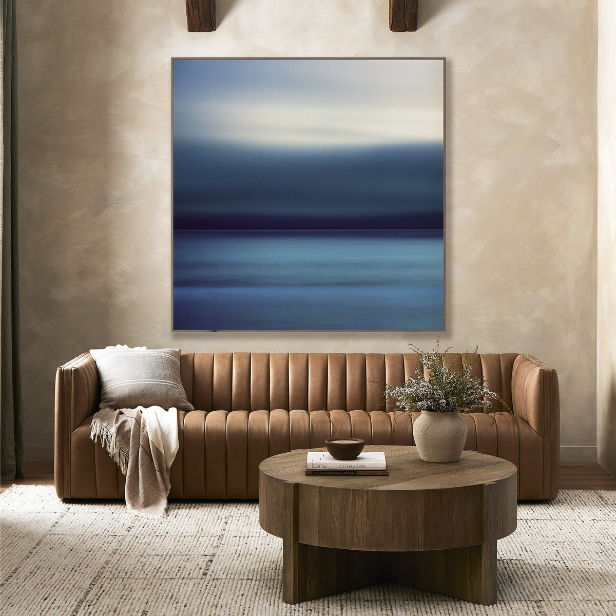 a living room with a couch and a painting on the wall