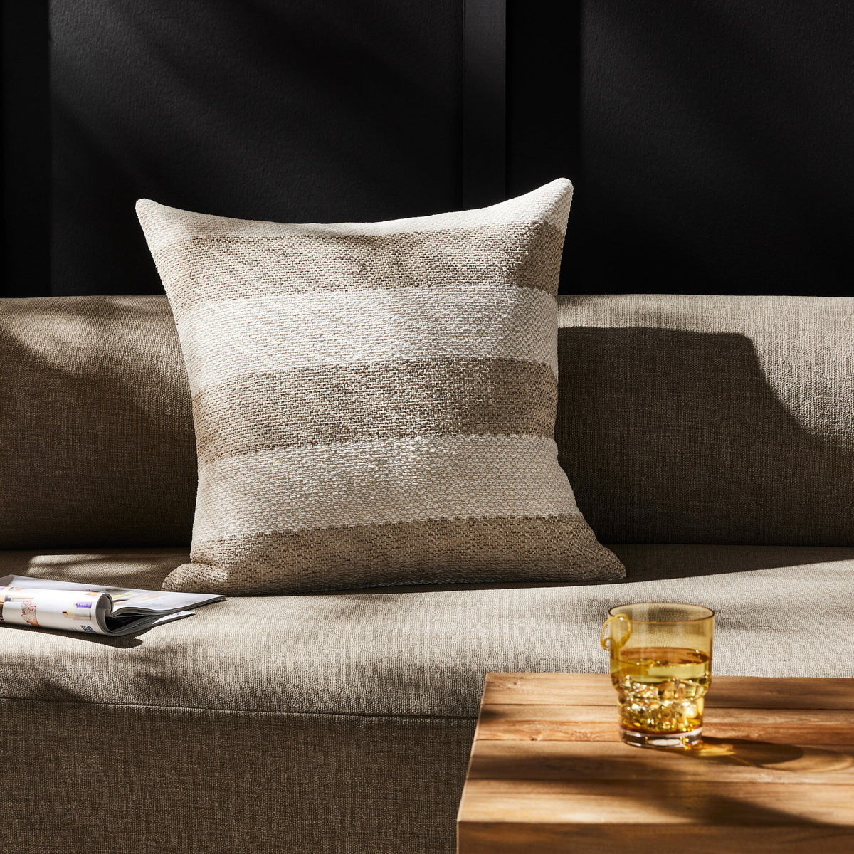 a couch with a glass of liquid on a table