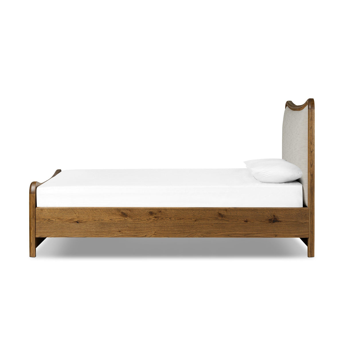 a wooden bed with a white sheet