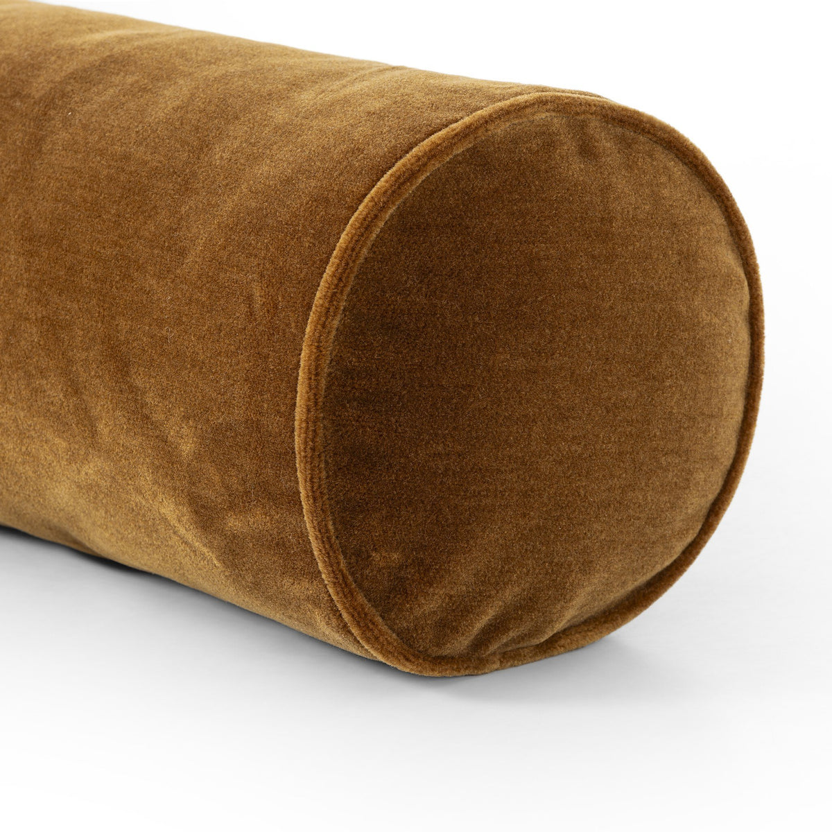 a brown pillow on a white surface