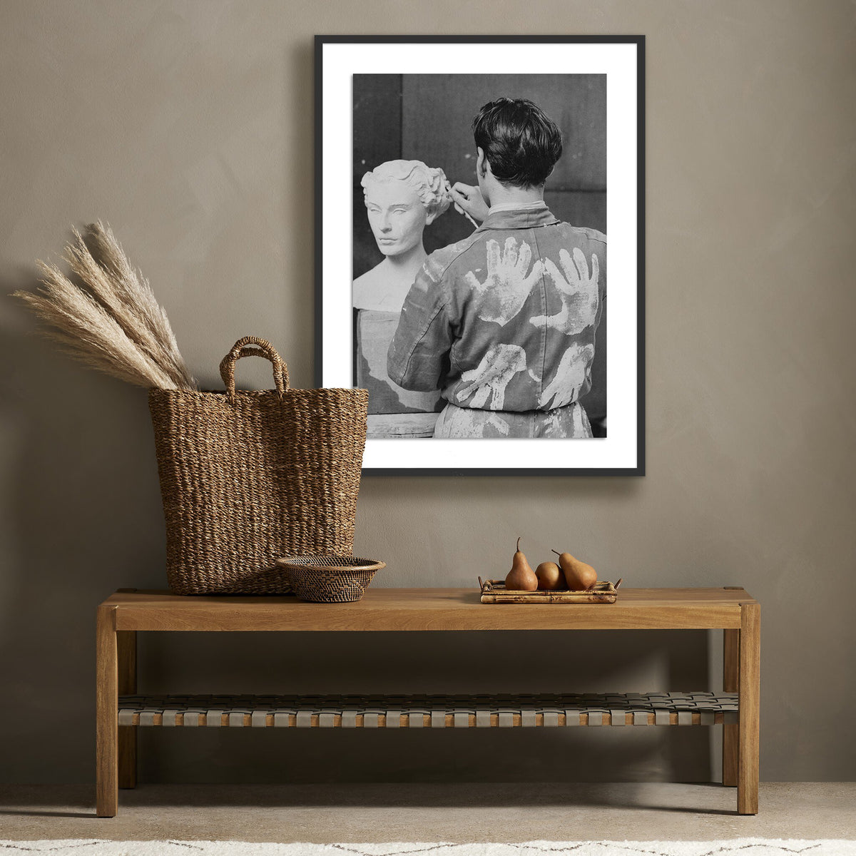 a bench with a basket and a picture of a man and woman