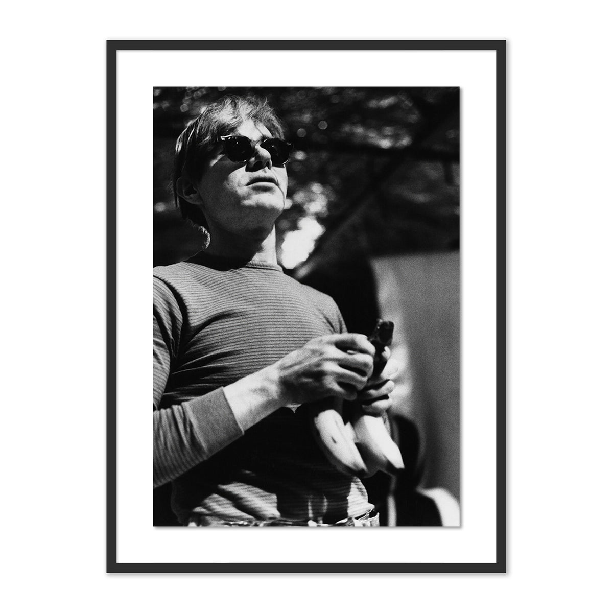 a man holding bananas in a frame