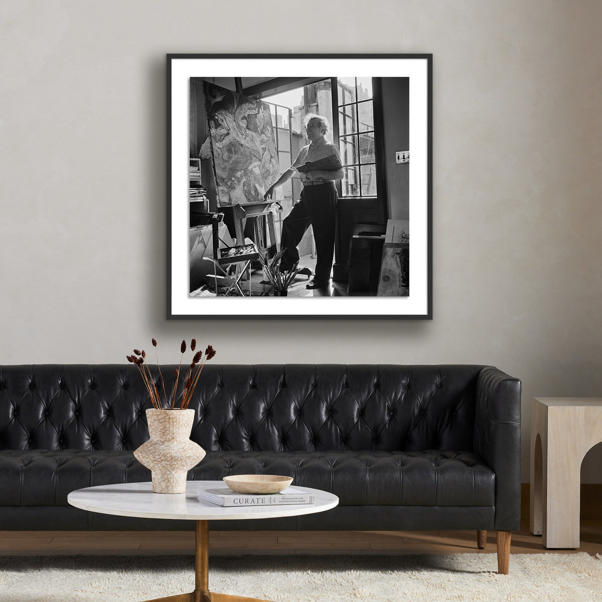 a black couch with a picture on the wall