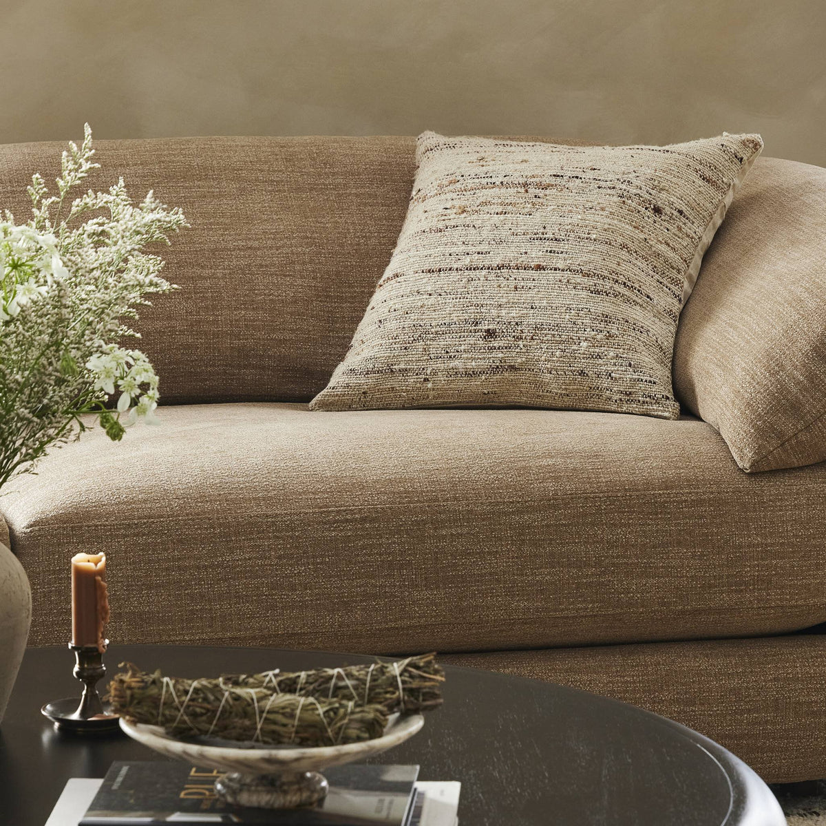 a couch with a vase of flowers