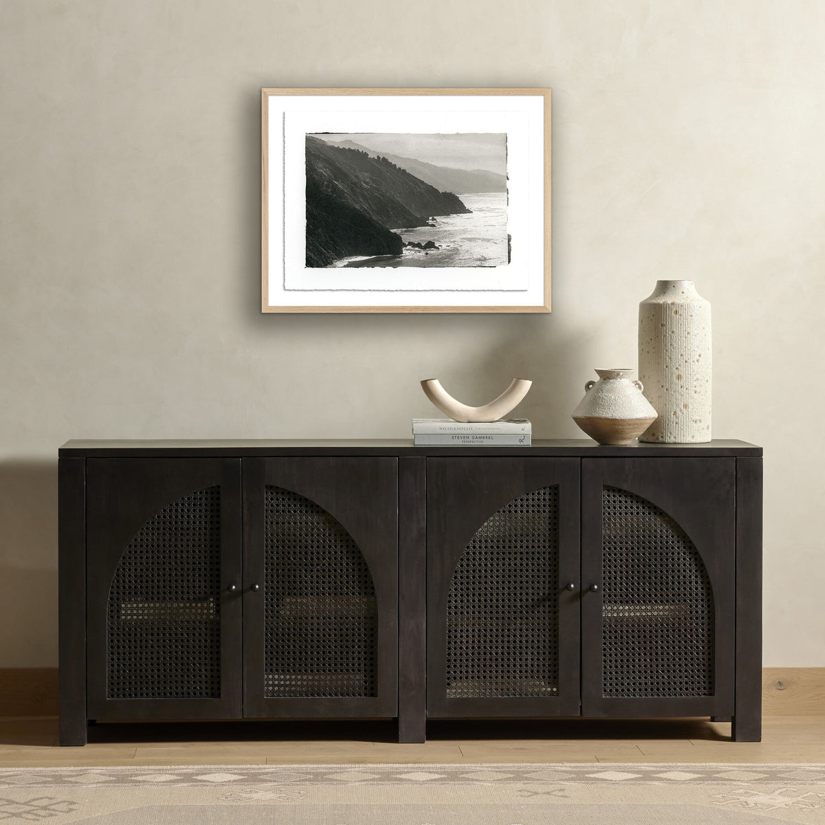 a black cabinet with a picture on the wall