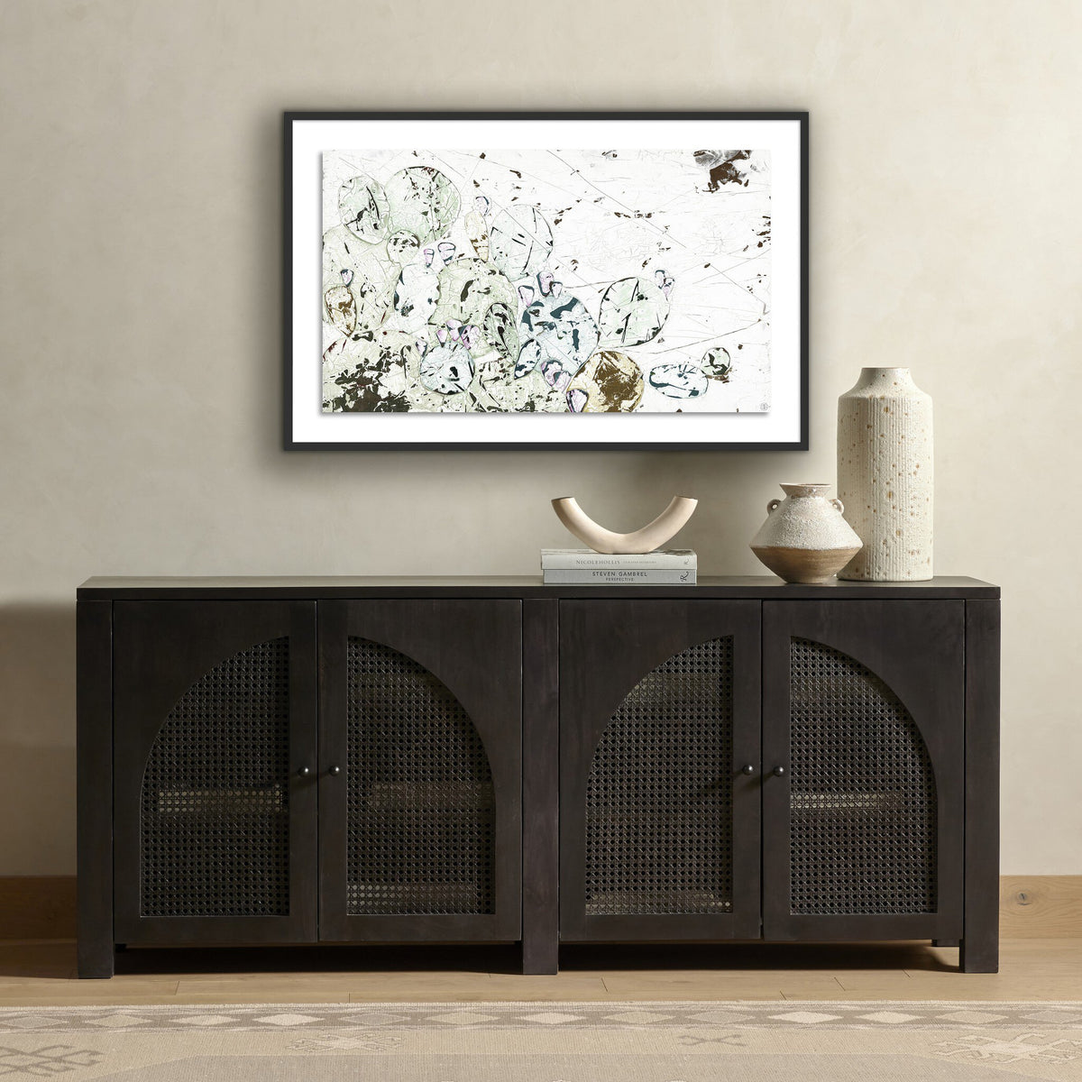 a black cabinet with a painting on the wall