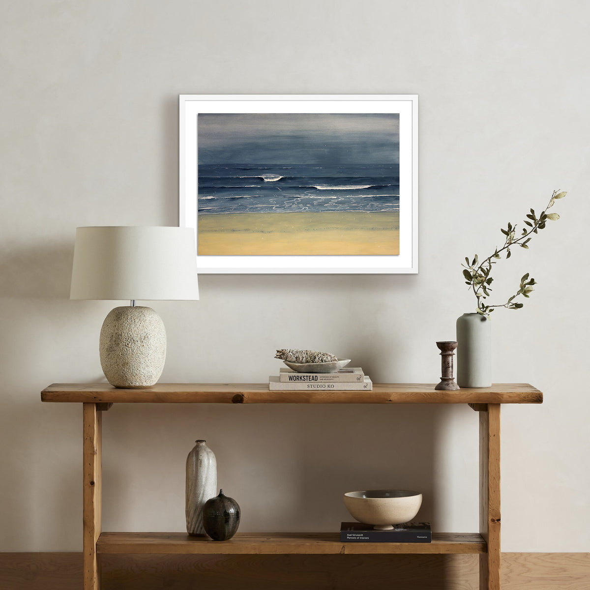 a table with a painting on the wall