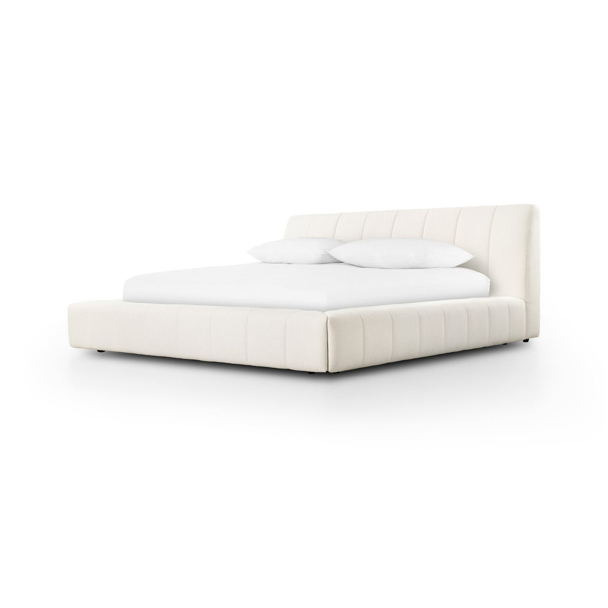a white bed with pillows