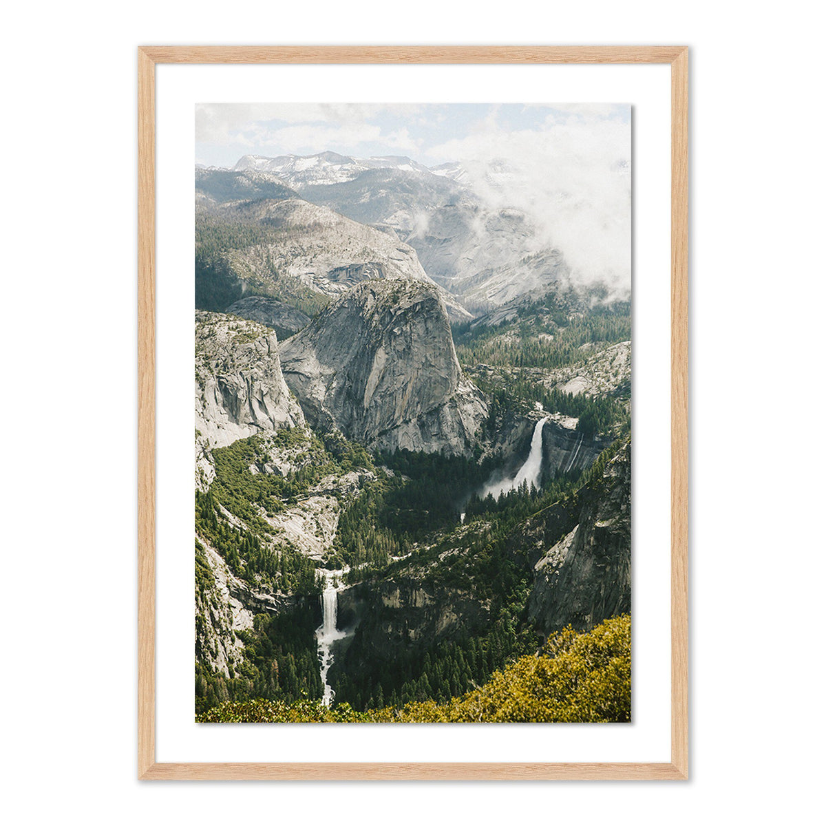 a framed picture of a mountain valley