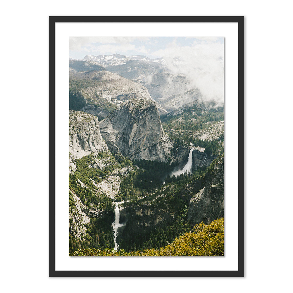 a framed picture of a river flowing through a valley