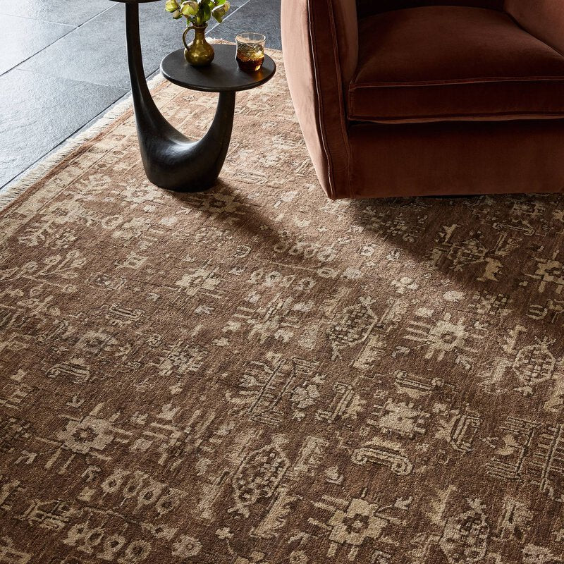 a brown rug with a brown chair and a table