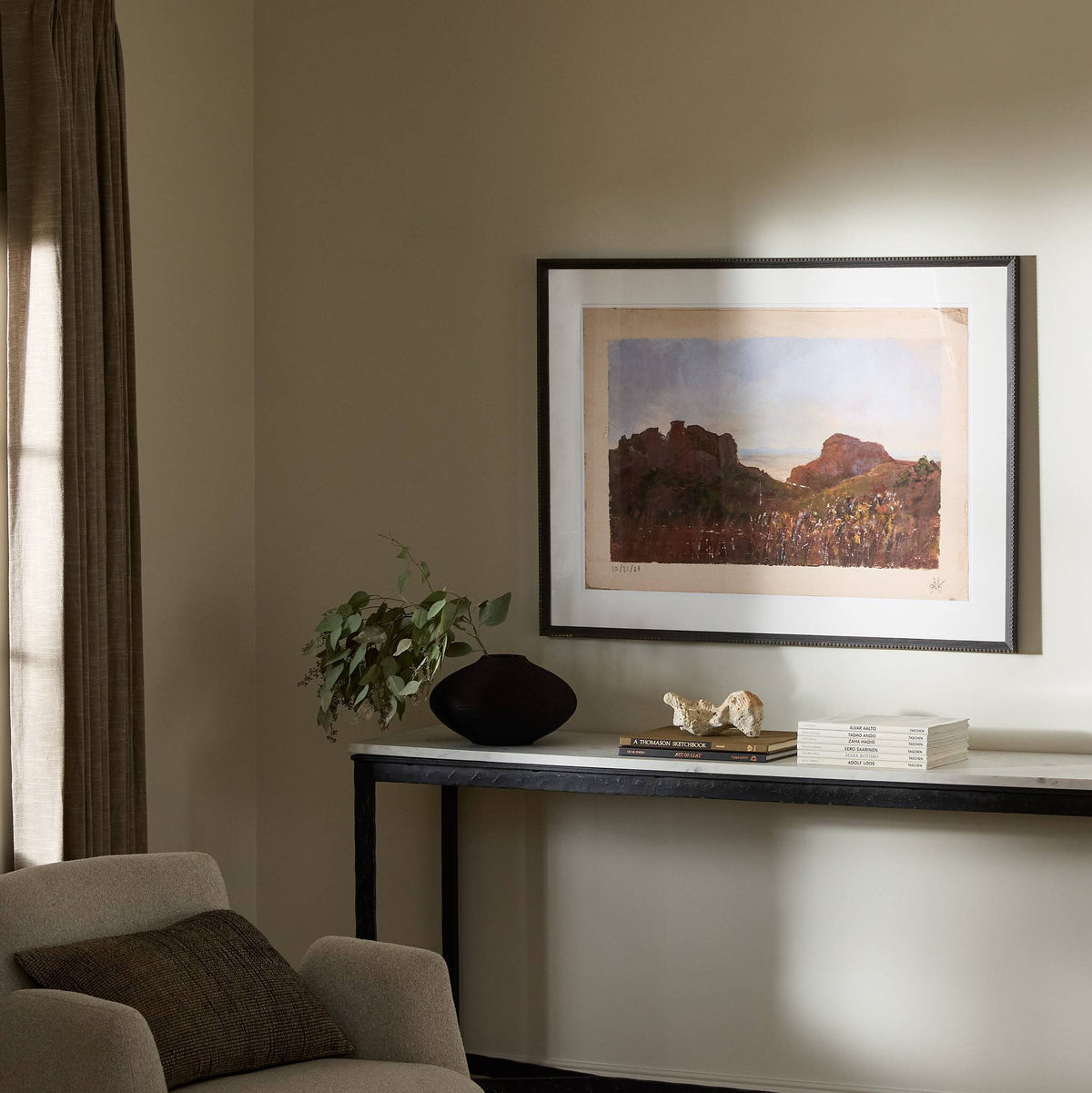 a room with a table and a painting on the wall