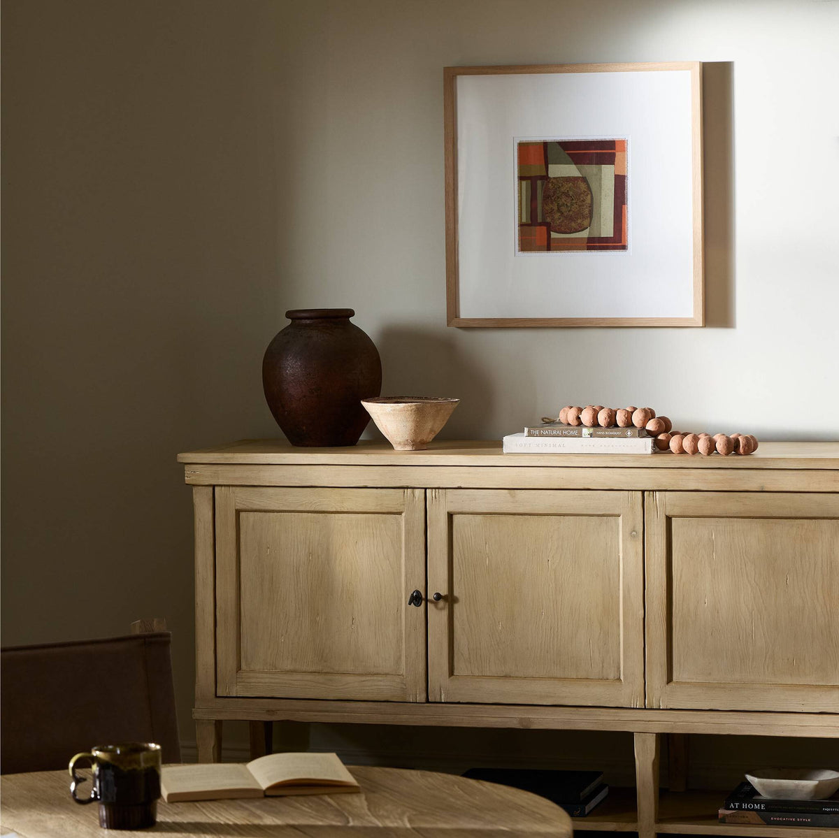 a table with a picture on the wall