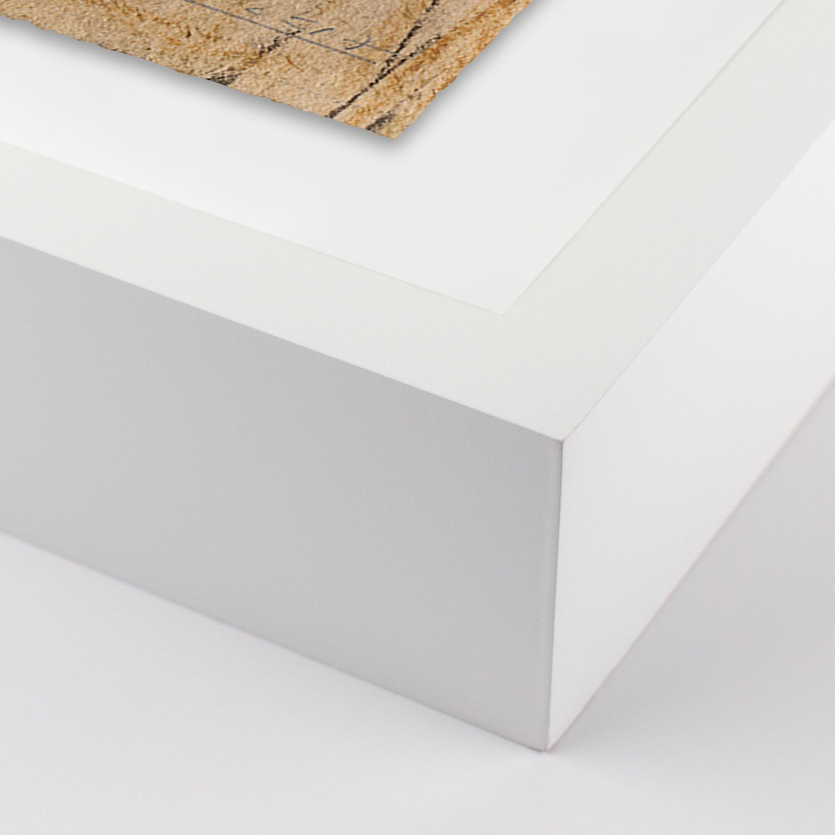 a white surface with a piece of wood