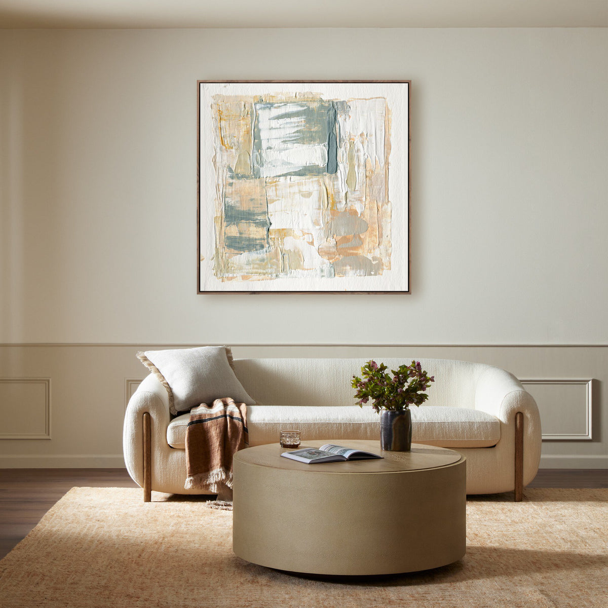 a living room with a couch and a painting on the wall