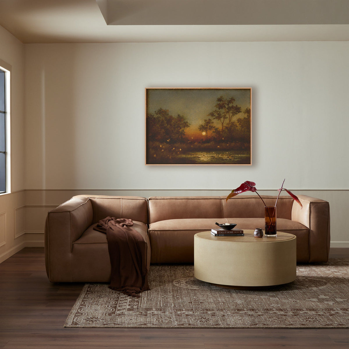 a living room with a couch and a painting on the wall