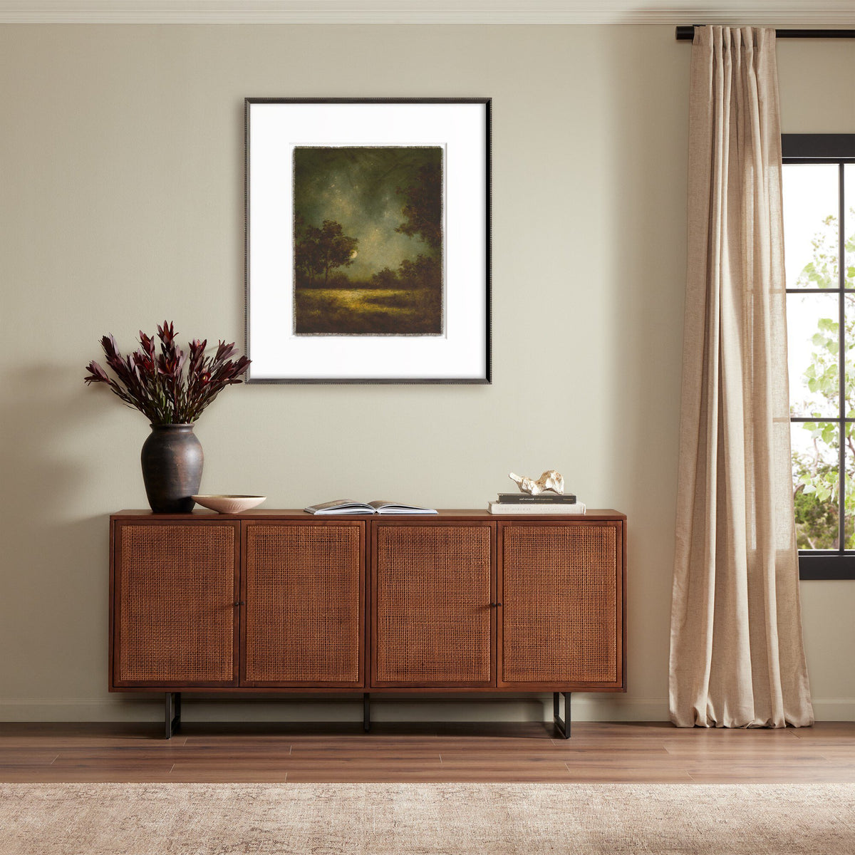 a room with a cabinet and a painting on the wall