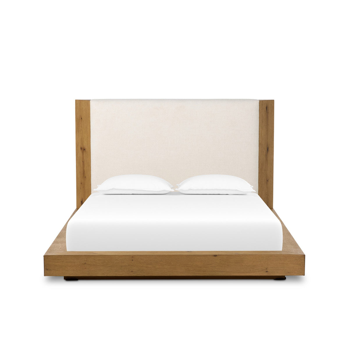 a bed with white sheets and a white headboard