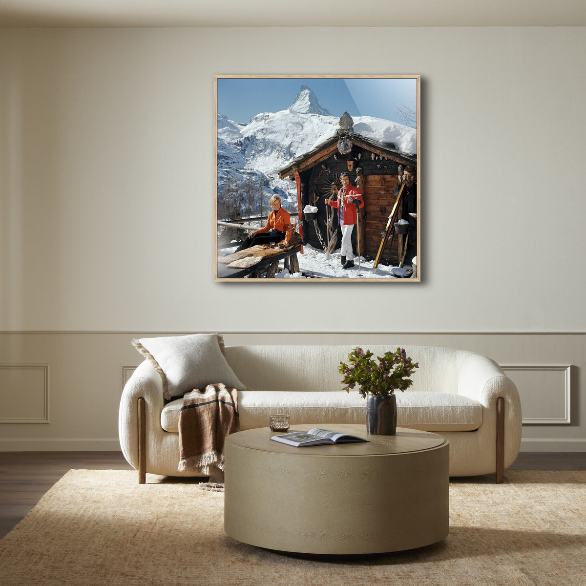 a living room with a picture of a cabin and a couch