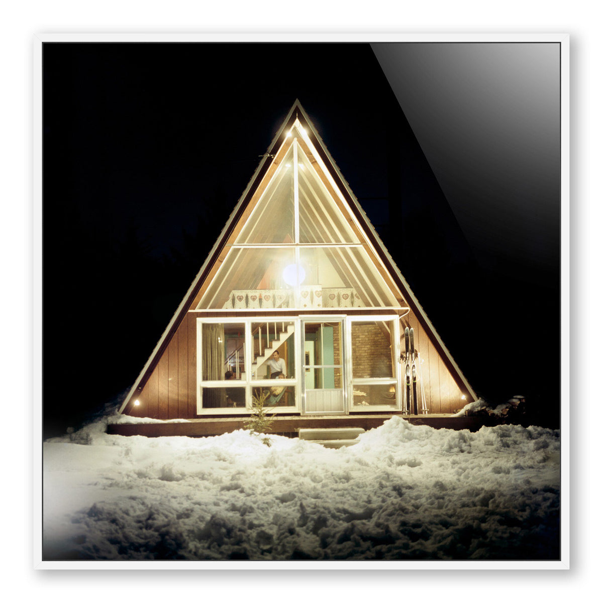 a triangular shaped house with lights
