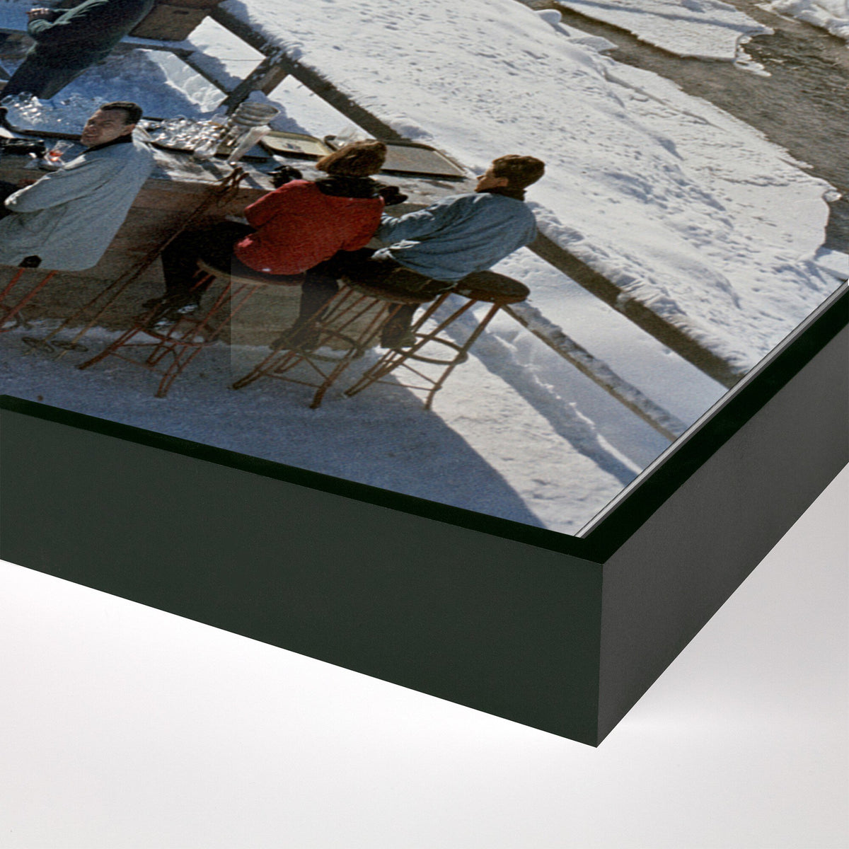 a group of people sitting at a table in the snow