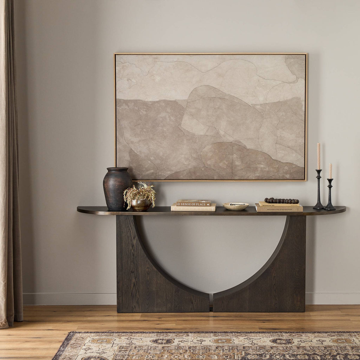 a table with a painting on the wall