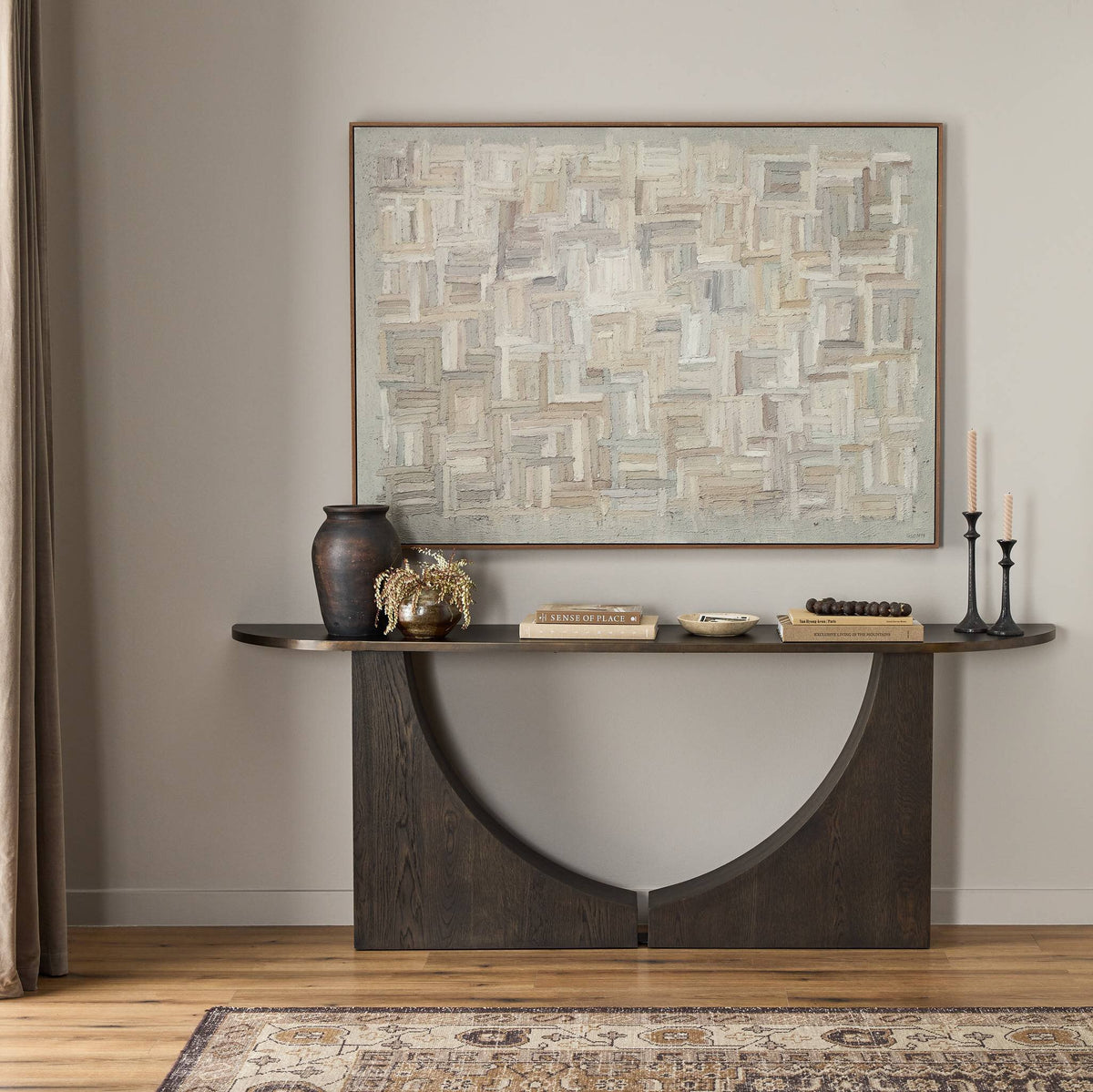 a table with a painting on the wall