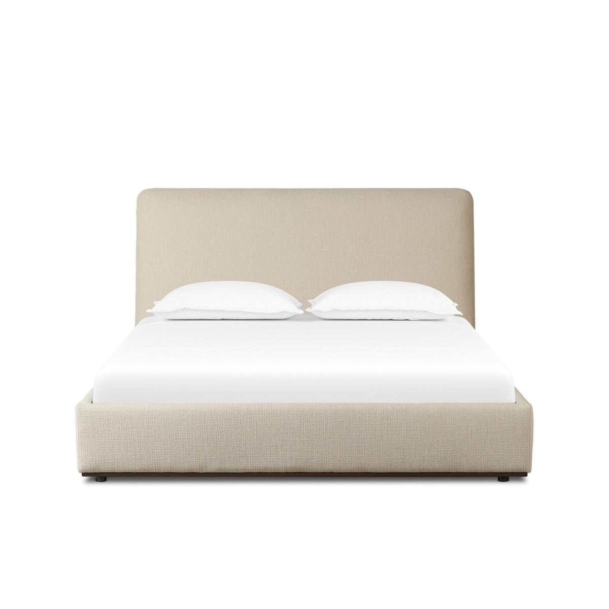 a bed with a white sheet and pillows