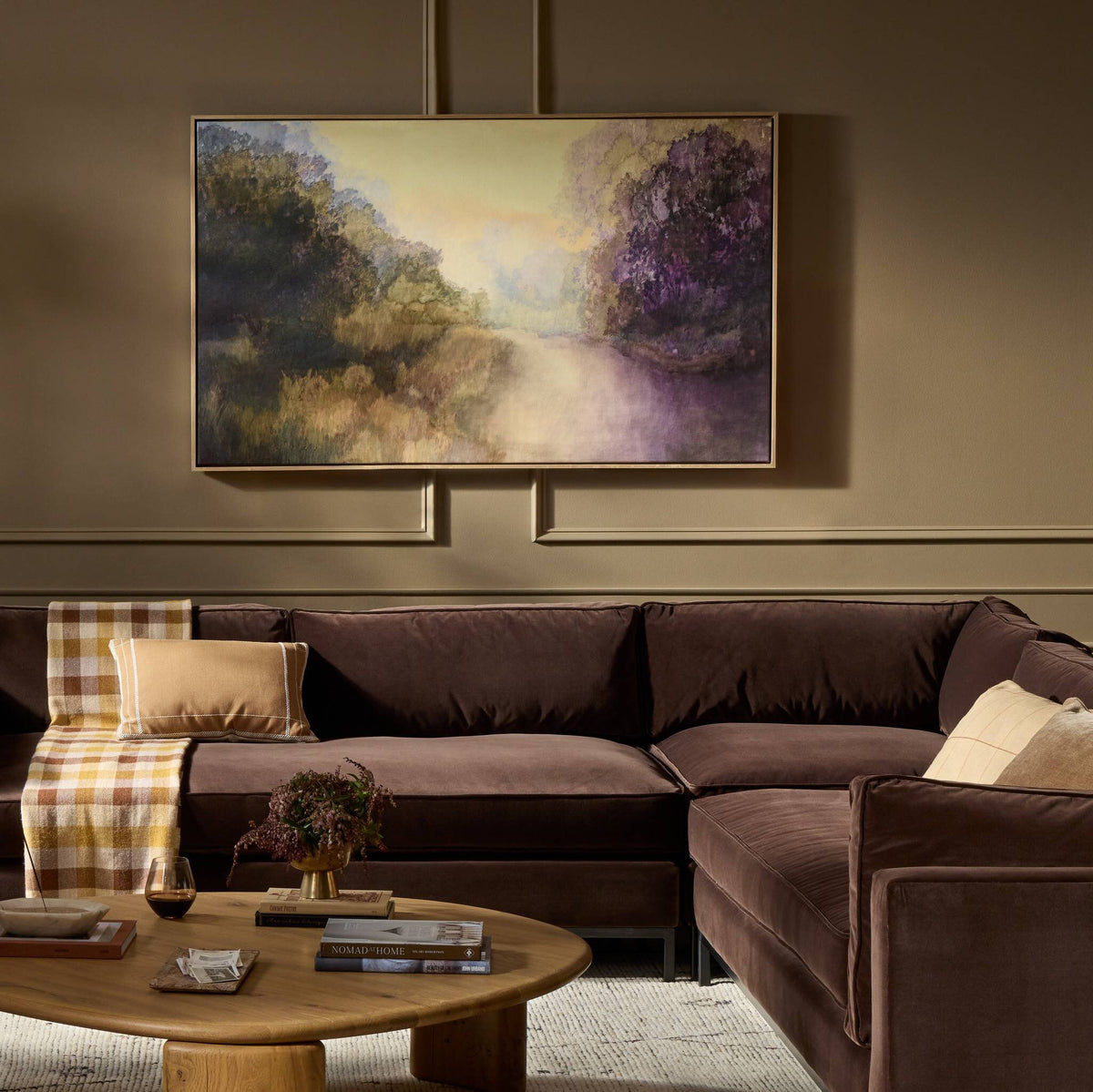 a living room with a large painting above a couch