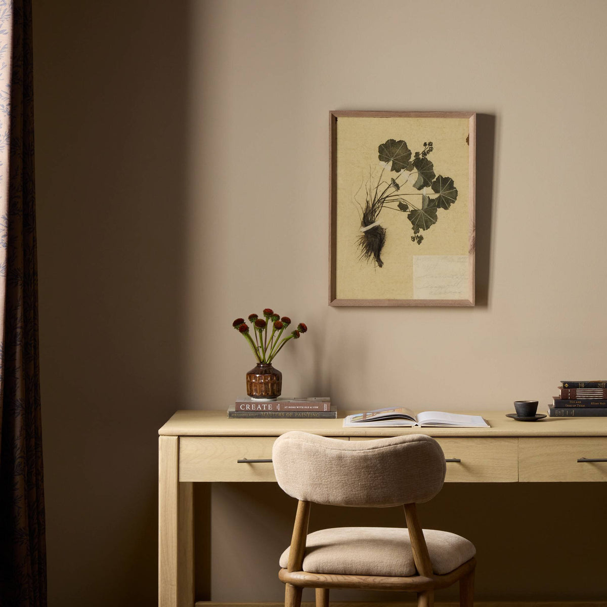 a desk with a chair and a picture on the wall