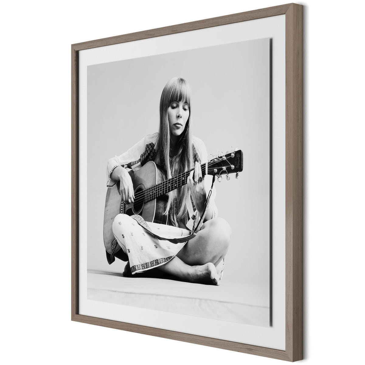 a framed picture of a woman playing guitar