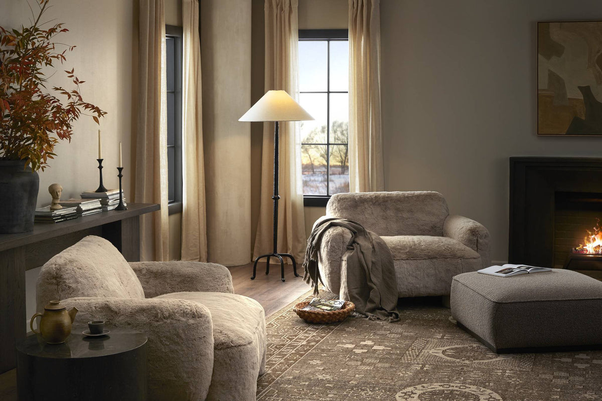 a living room with a couch and a lamp