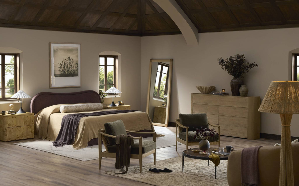 a bedroom with a bed and chairs