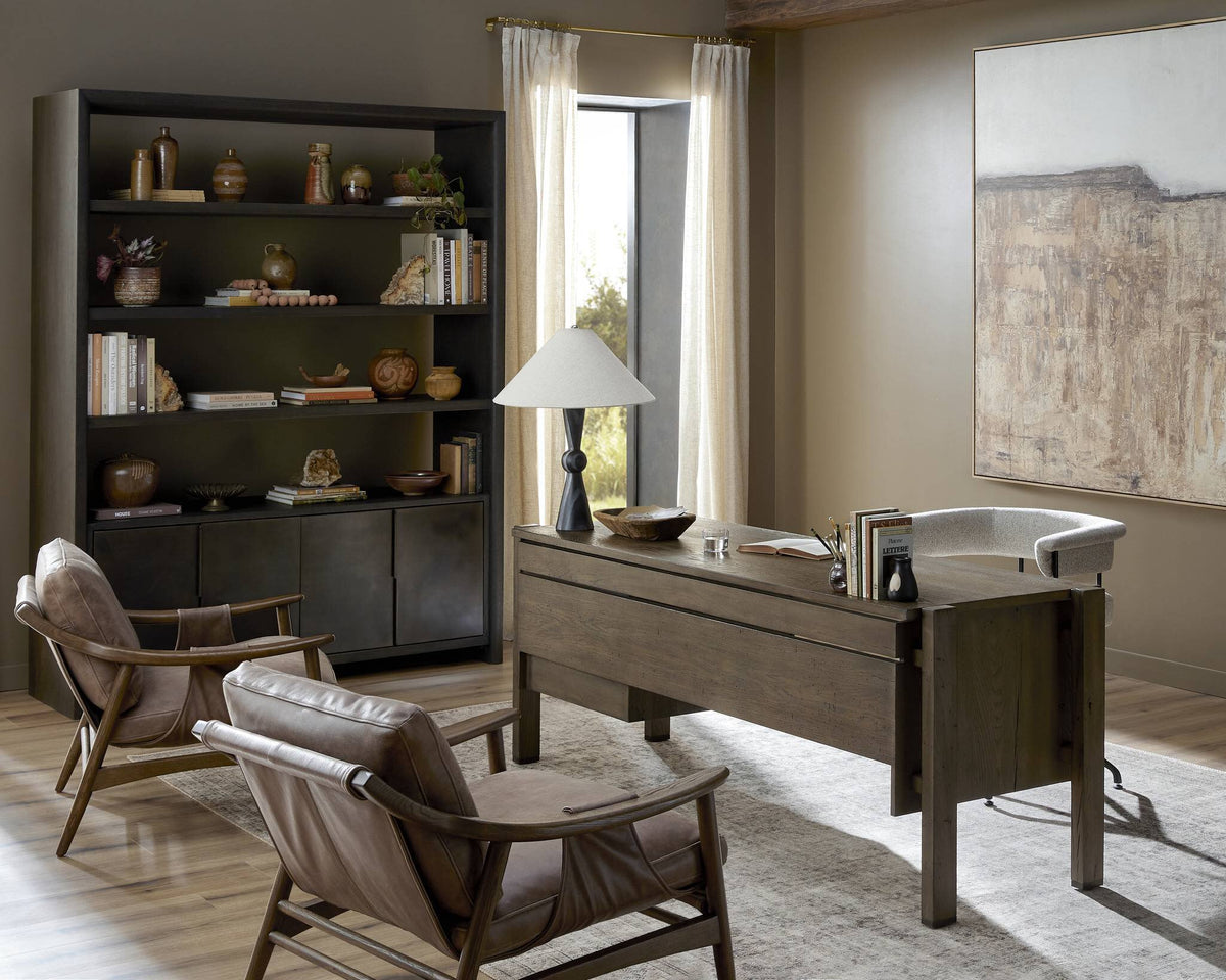 a room with a desk and chairs