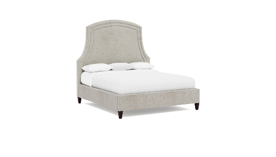 a bed with white sheets and pillows