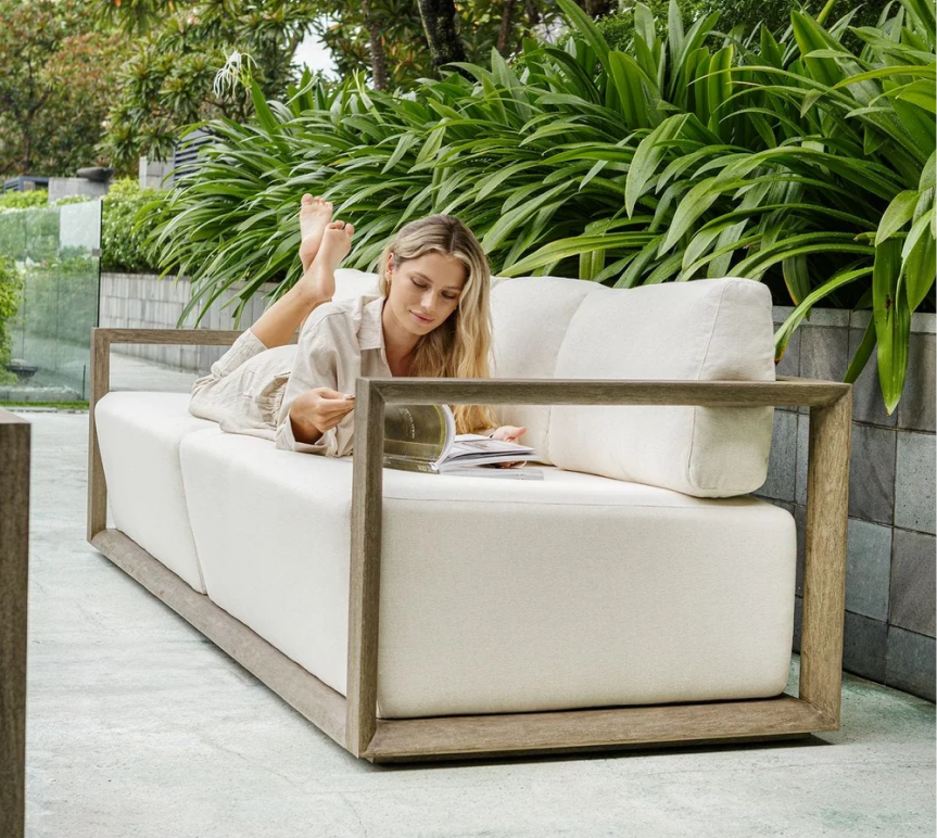 a woman lying on a white couch