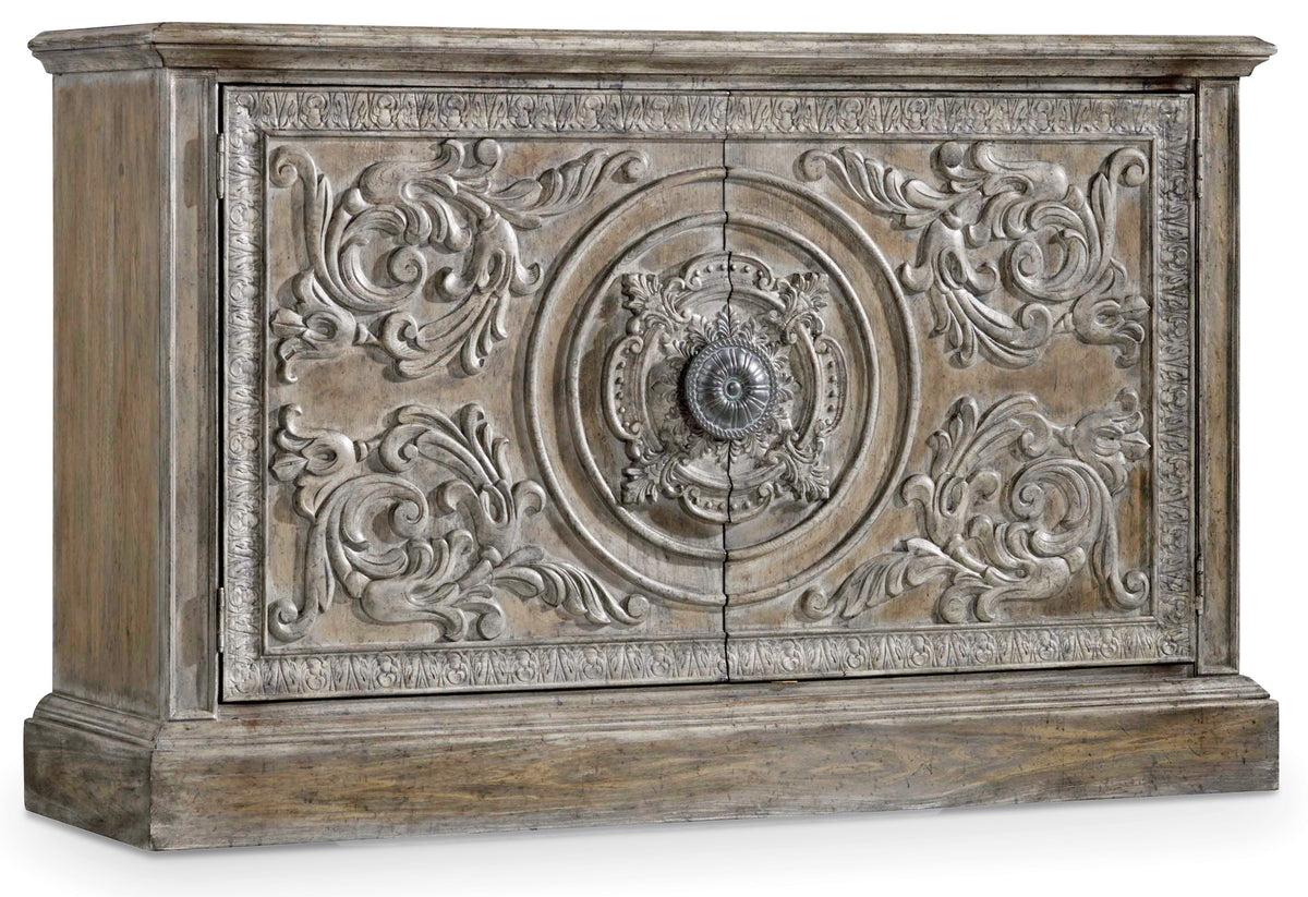 a carved wood panel with a round knob