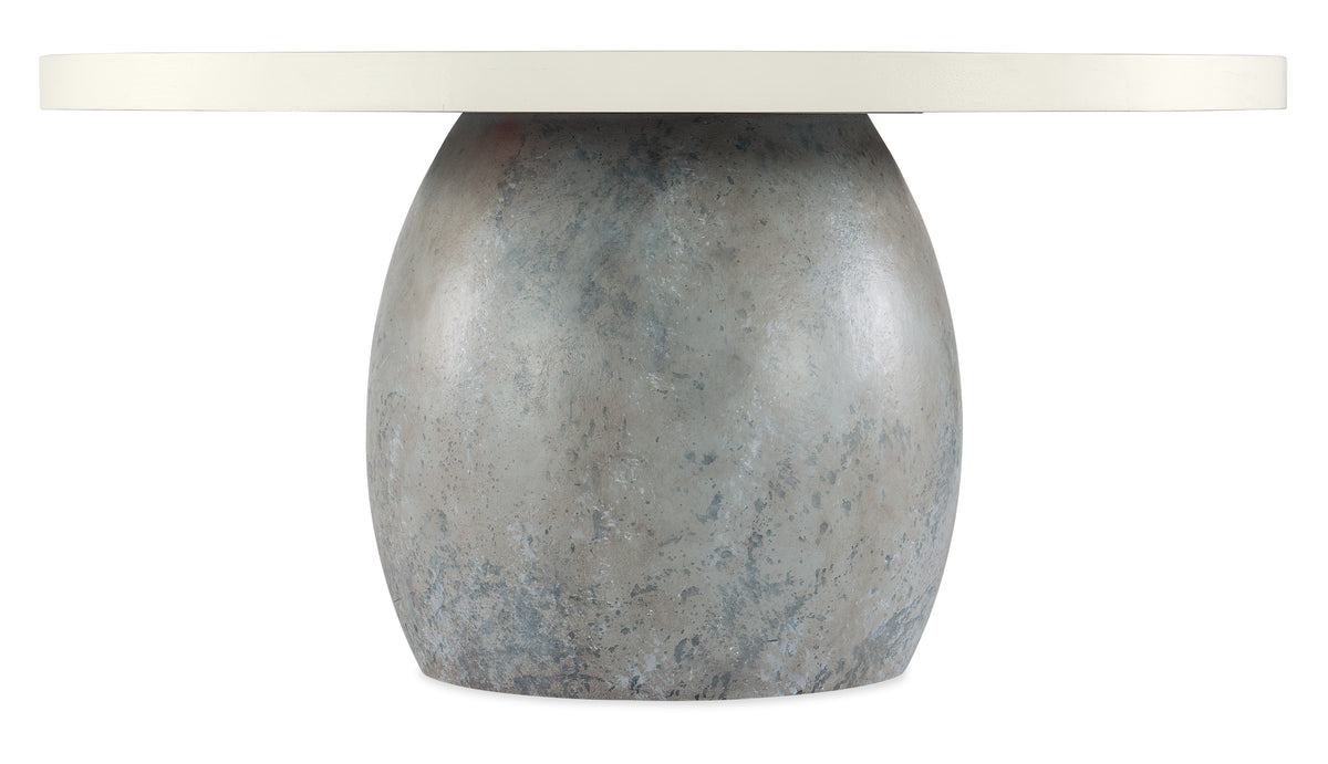 a round stone table with a white surface