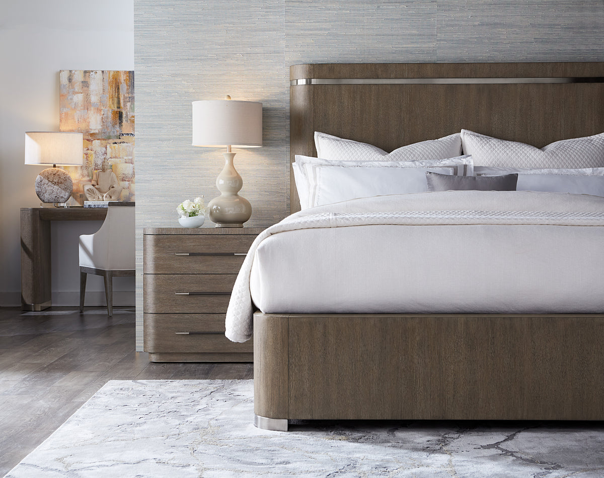a bed with a lamp on the side